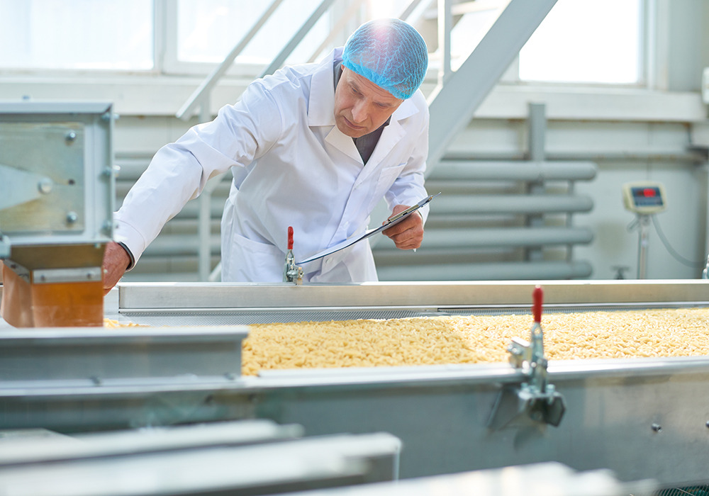 man servicing conveyor machinery