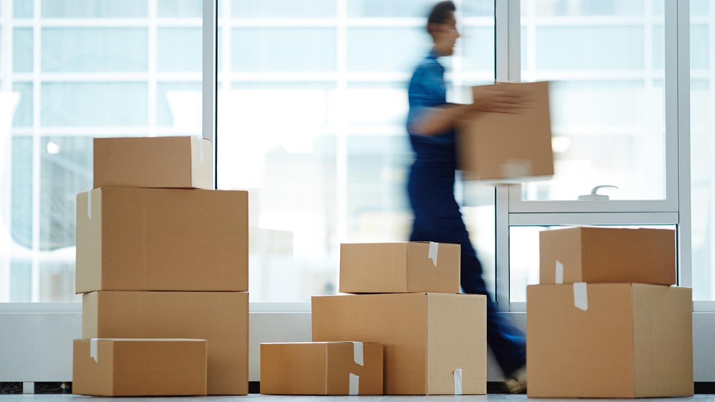 Moving parcel with stacked boxes on floor