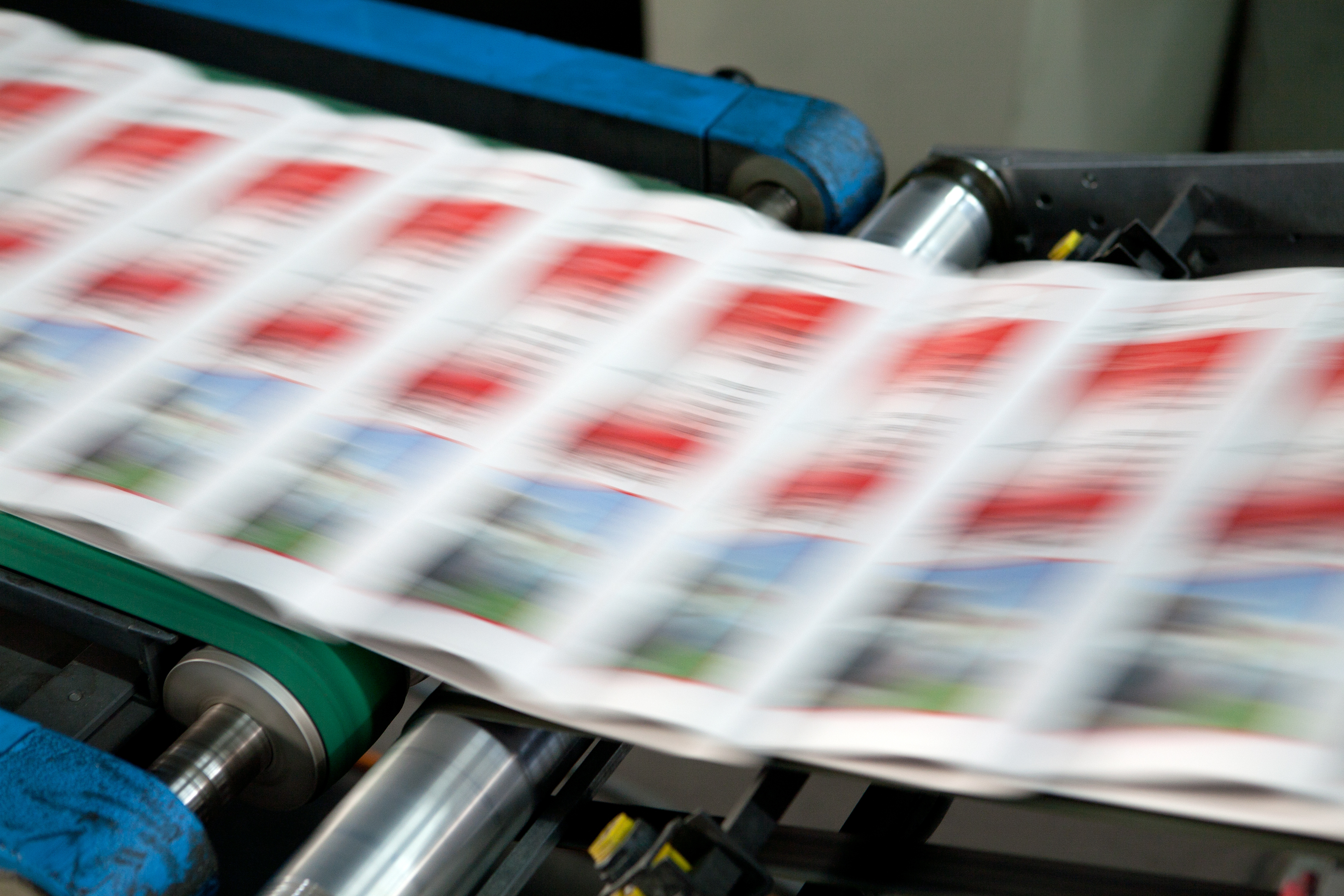 Newspapers on high-speed conveyor