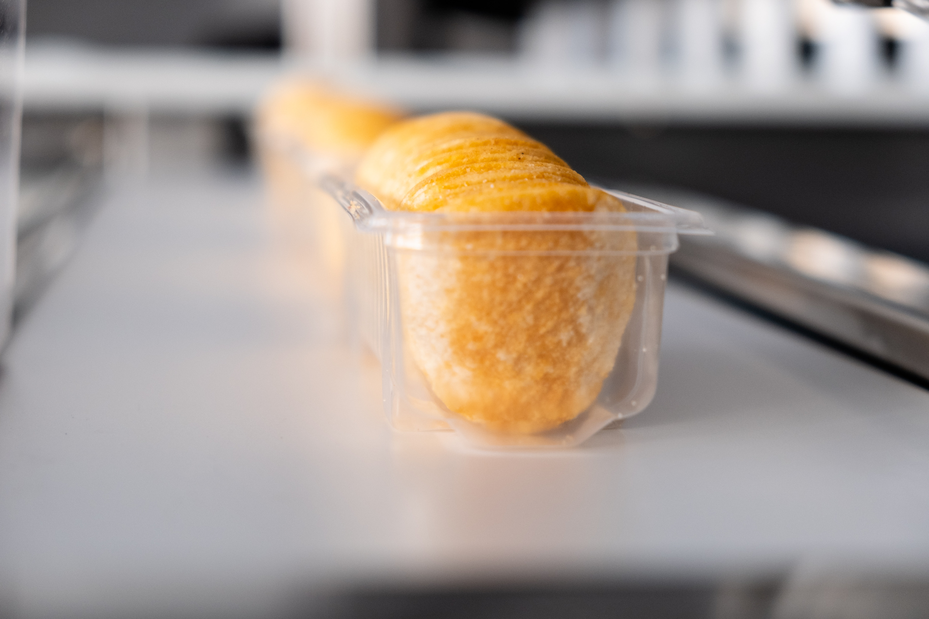 chips in transparent box on conveyor belt